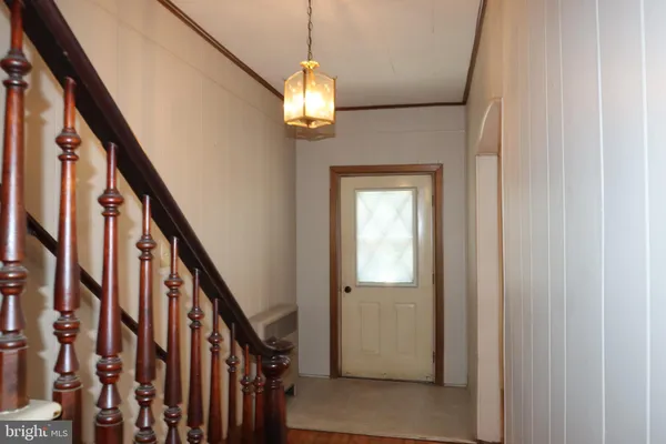 a view of an entryway with wooden floor and stairs