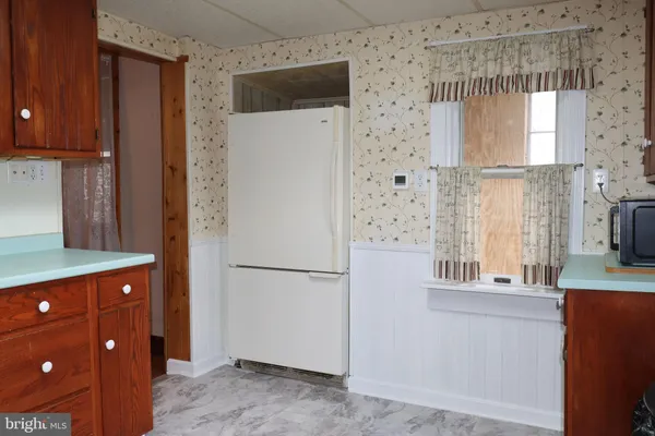 a kitchen with a refrigerator and a sink
