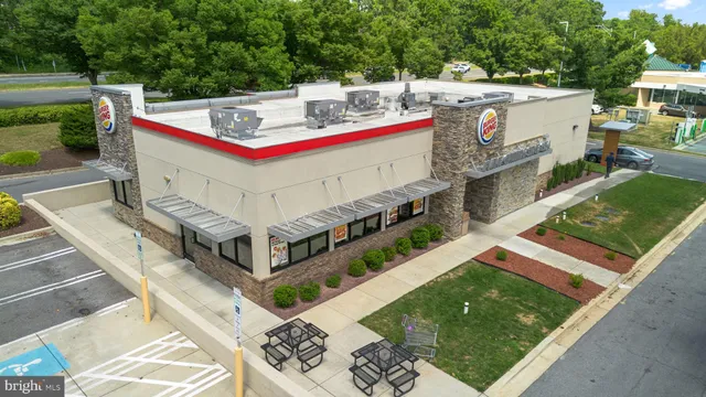 a view of a patio with table and chairs potted plants with wooden floor and fence