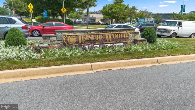 a view of a bunch of flowers and cars parked in yard