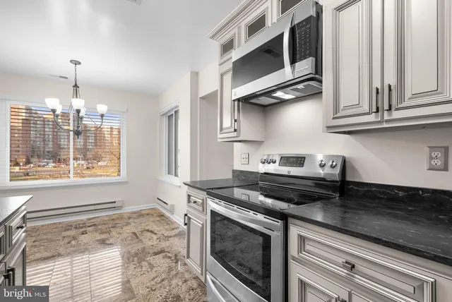 a kitchen with stainless steel appliances granite countertop a stove and a sink