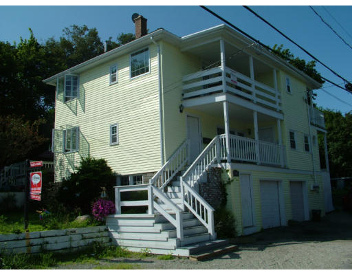 84 Mountford Road Hull, MA 02045 - Photo 2 of 30 a view of wooden house with a small yard and potted plants
