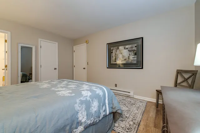 a bedroom with a bed and a painting on the wall