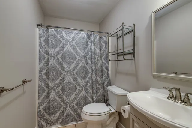 a bathroom with a toilet sink and shower