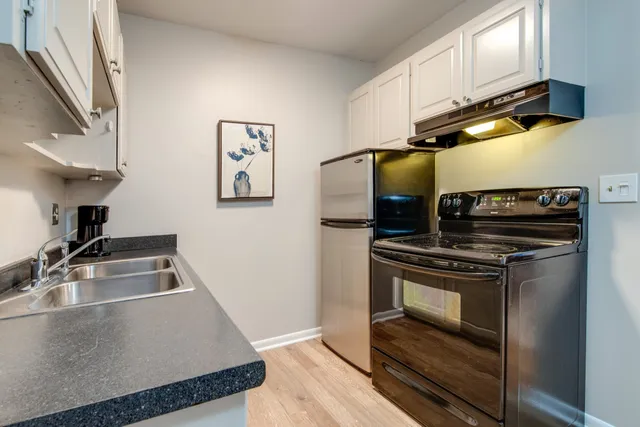 a kitchen with stainless steel appliances a stove a sink and a refrigerator