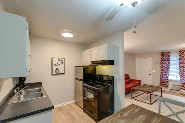 a kitchen with a refrigerator stove and sink