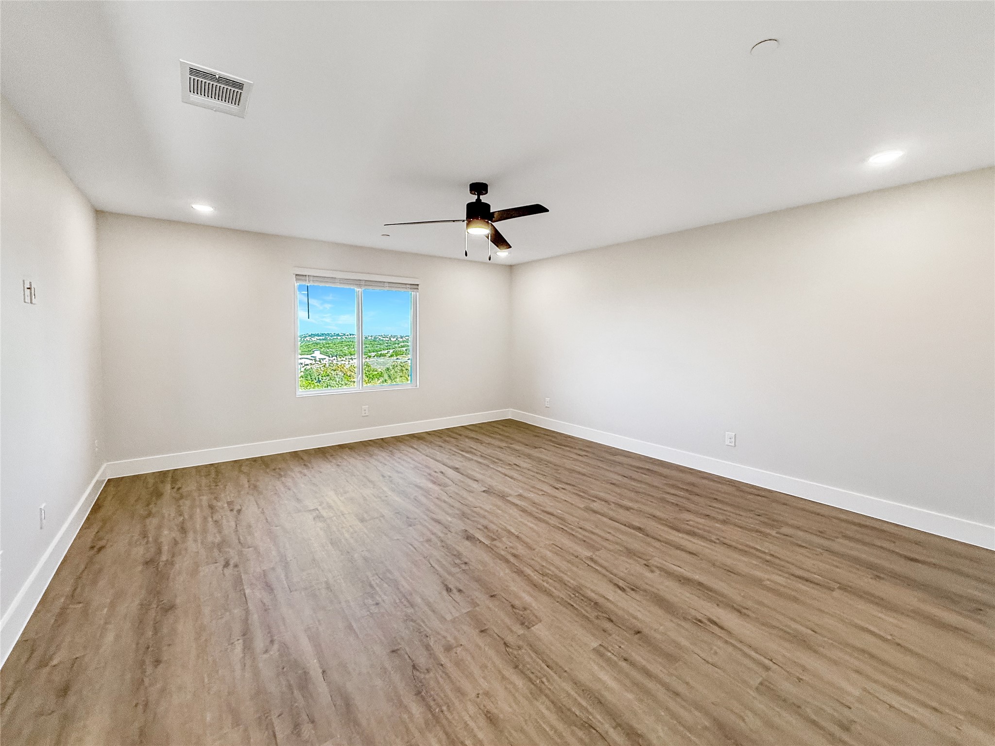 5607 Mobeetie Loop Bee Cave, TX 78738 - Photo 11 of 21 wooden floor in an empty room with a window
