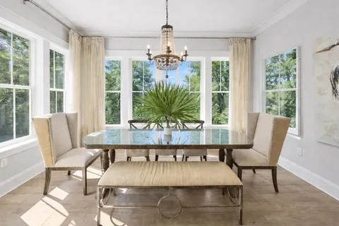 a dining room with furniture and a chandelier