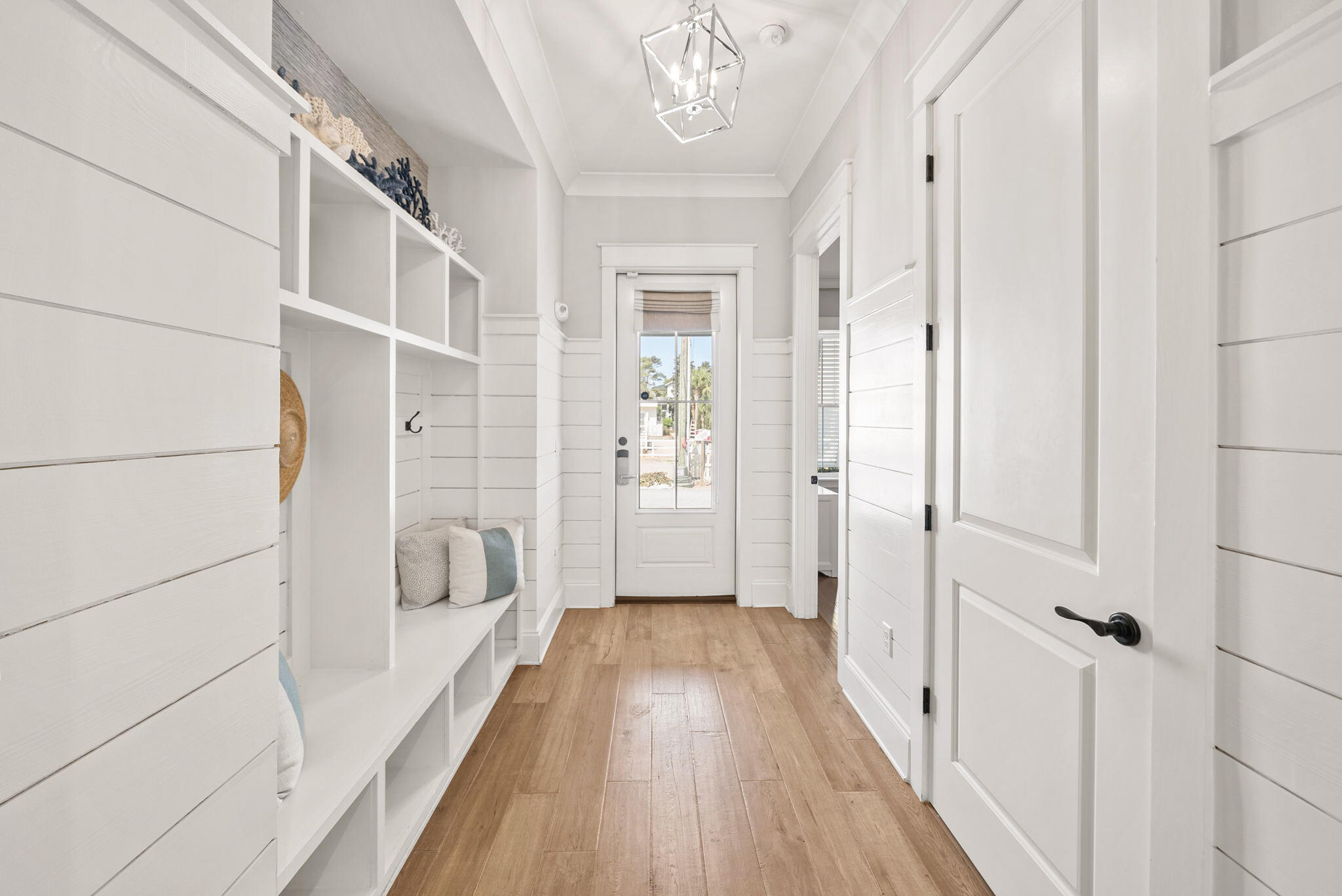 76 Brown Street Santa Rosa Beach, FL 32459 - Photo 16 of 48 a view of a hallway with wooden floor and staircase
