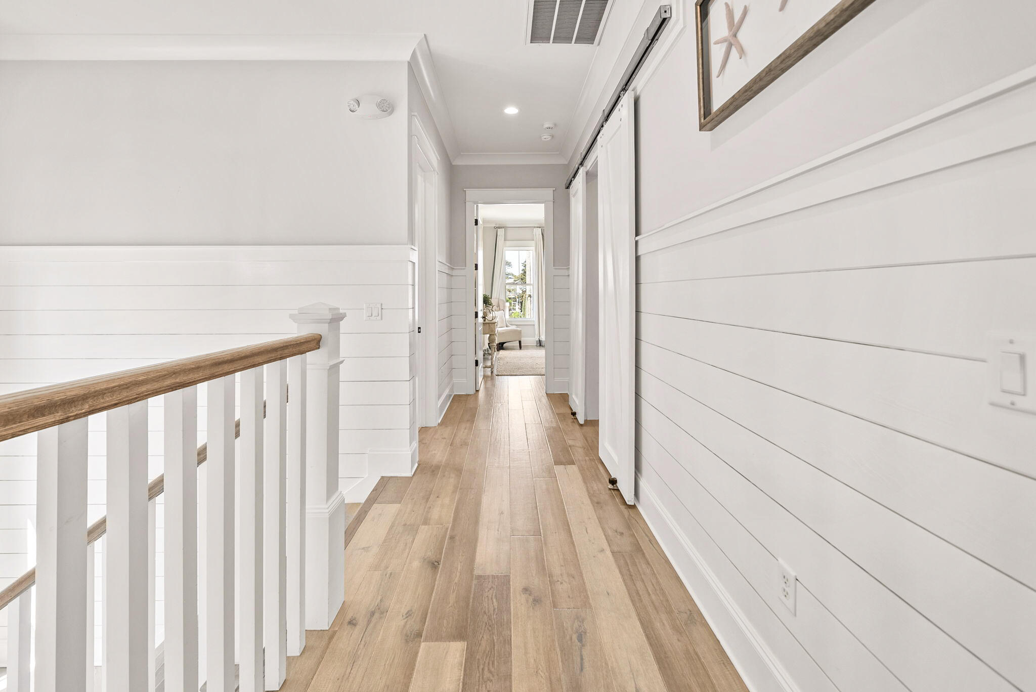 76 Brown Street Santa Rosa Beach, FL 32459 - Photo 20 of 48 a view of a hallway with wooden floor and staircase