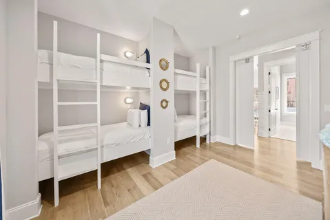 a hall way with furniture a mirror and a balcony