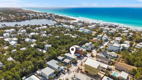 a view of a house with a tree and a yard