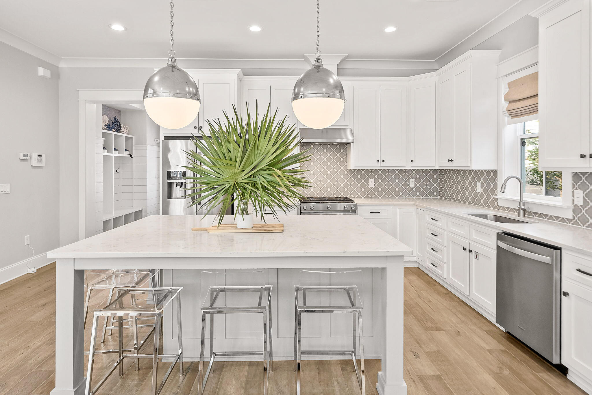 76 Brown Street Santa Rosa Beach, FL 32459 - Photo 6 of 48 a kitchen with a white cabinets and chairs