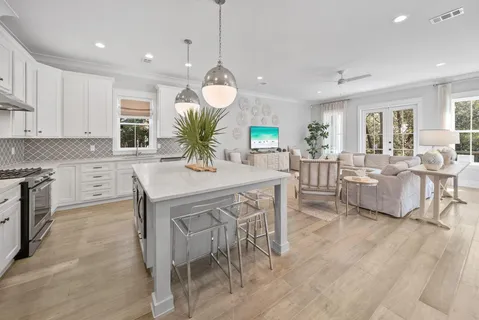 a kitchen with stainless steel appliances granite countertop a kitchen island a stove a table and chairs in it