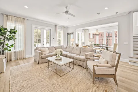 a dining room with furniture a chandelier and wooden floor