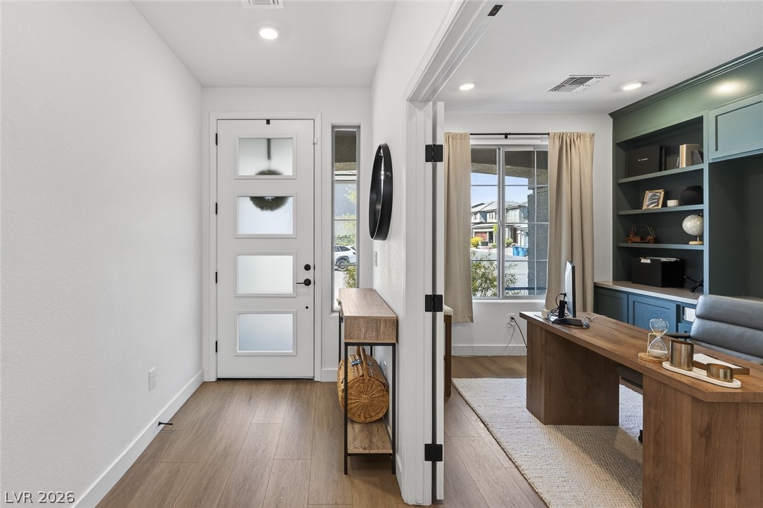 10446 Emerald Rye Street Las Vegas, NV 89183 - Photo 3 of 37 Step inside this inviting home featuring wood flooring and a separate office space with built-in shelving.