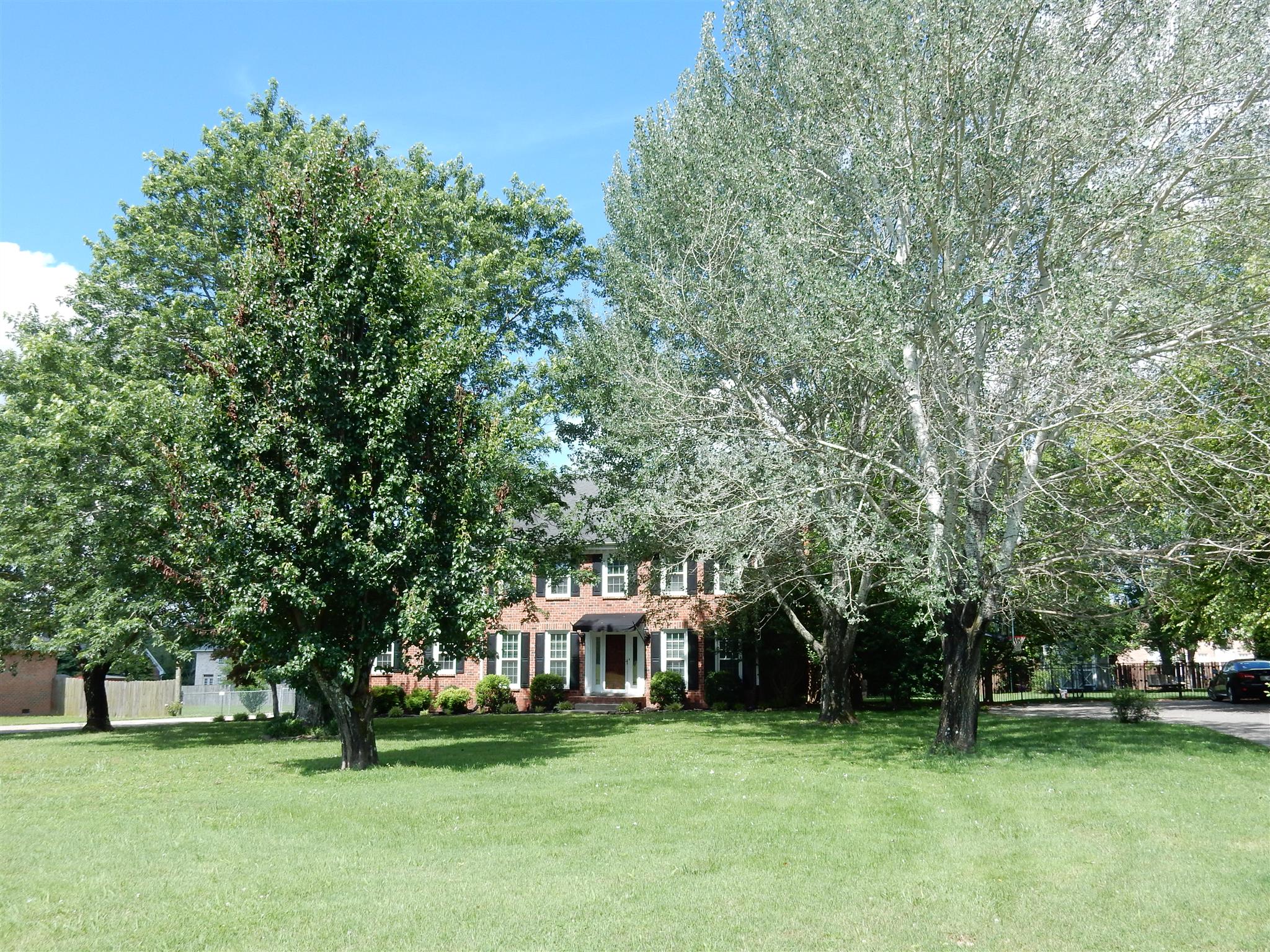 2884 Cages Bend Road Gallatin, TN 37066 - Photo 2 of 26 a view of a house with a big yard and large trees