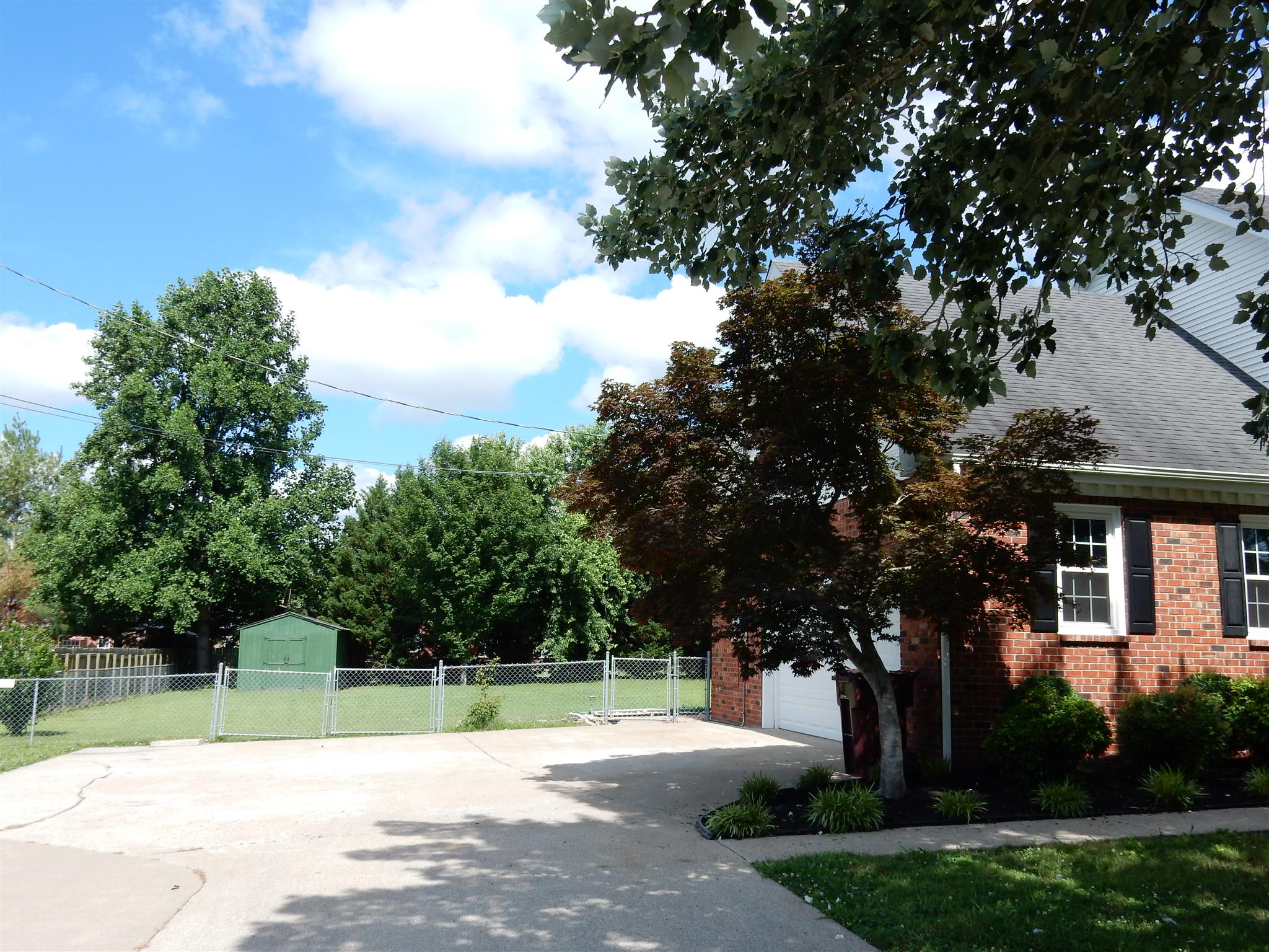 2884 Cages Bend Road Gallatin, TN 37066 - Photo 24 of 26 a white house with a big yard and large trees