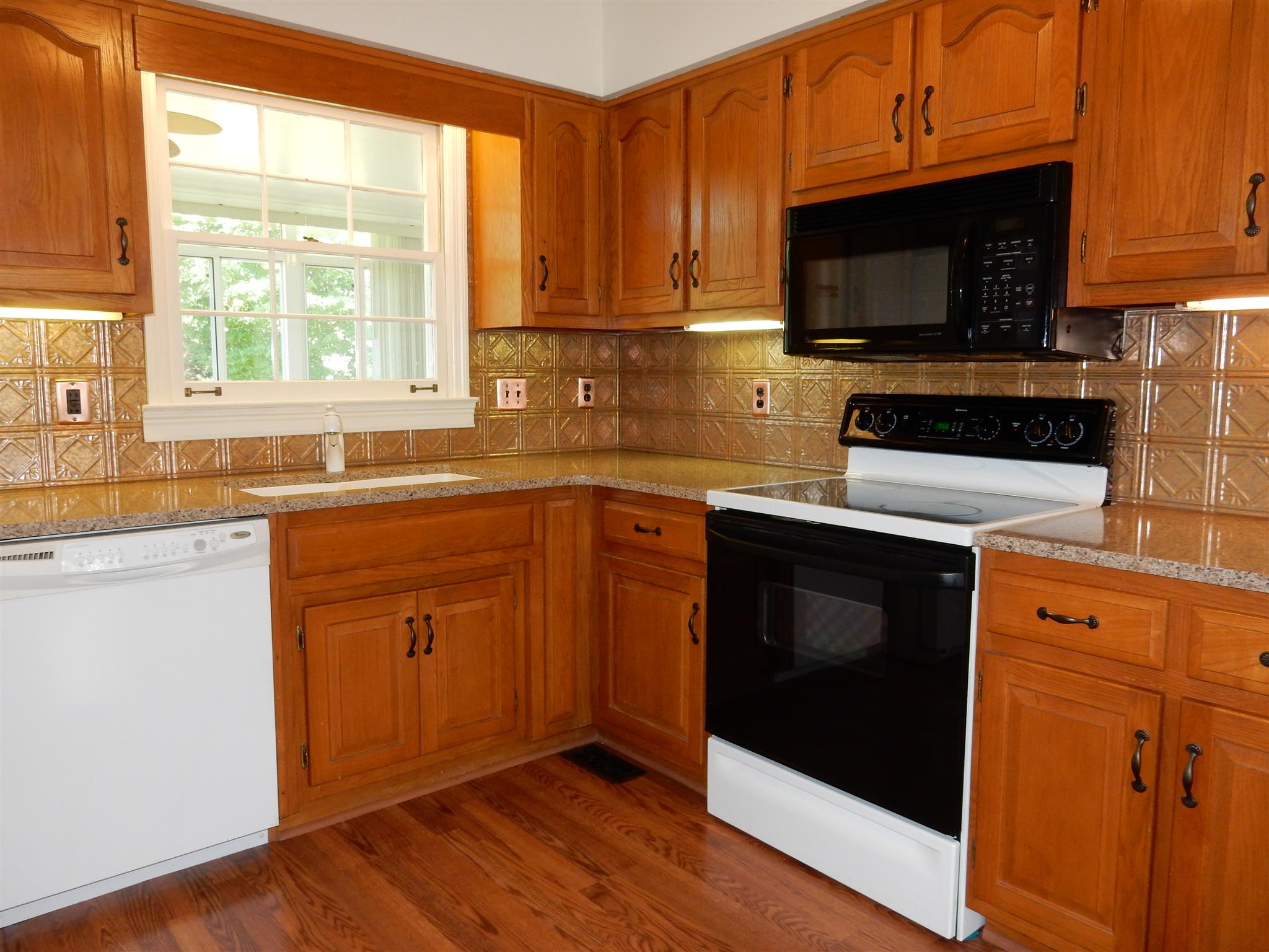 2884 Cages Bend Road Gallatin, TN 37066 - Photo 8 of 26 a kitchen with stainless steel appliances a stove a sink and a microwave