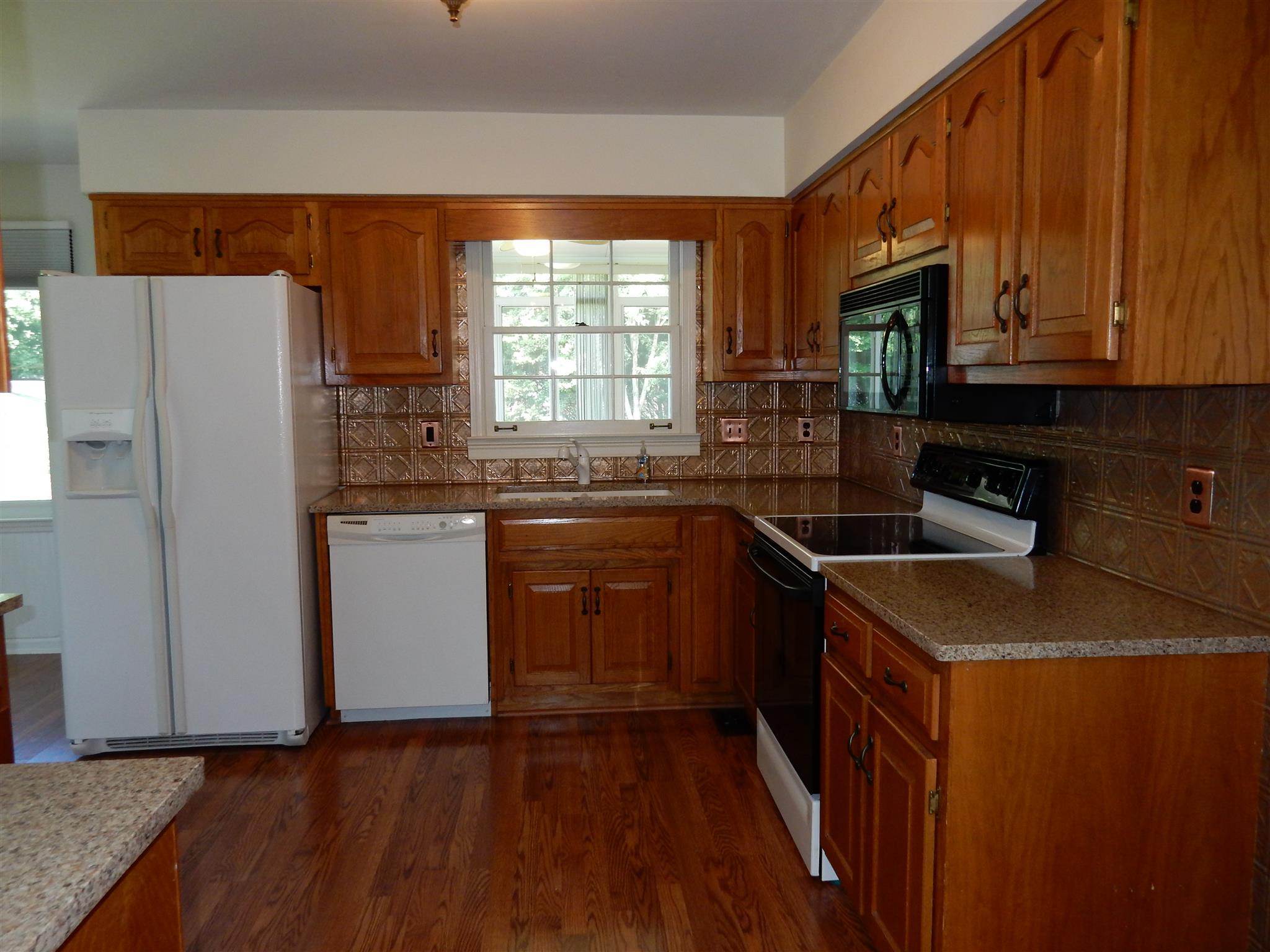 2884 Cages Bend Road Gallatin, TN 37066 - Photo 9 of 26 a kitchen with granite countertop a sink stove and refrigerator