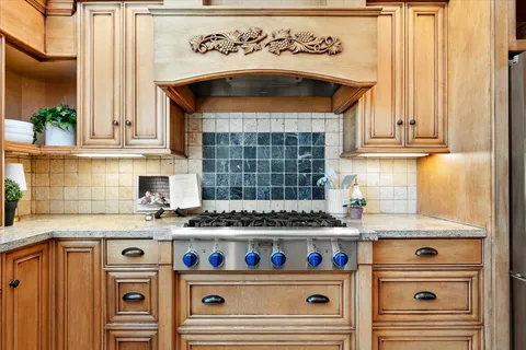 a kitchen with a stove and cabinets