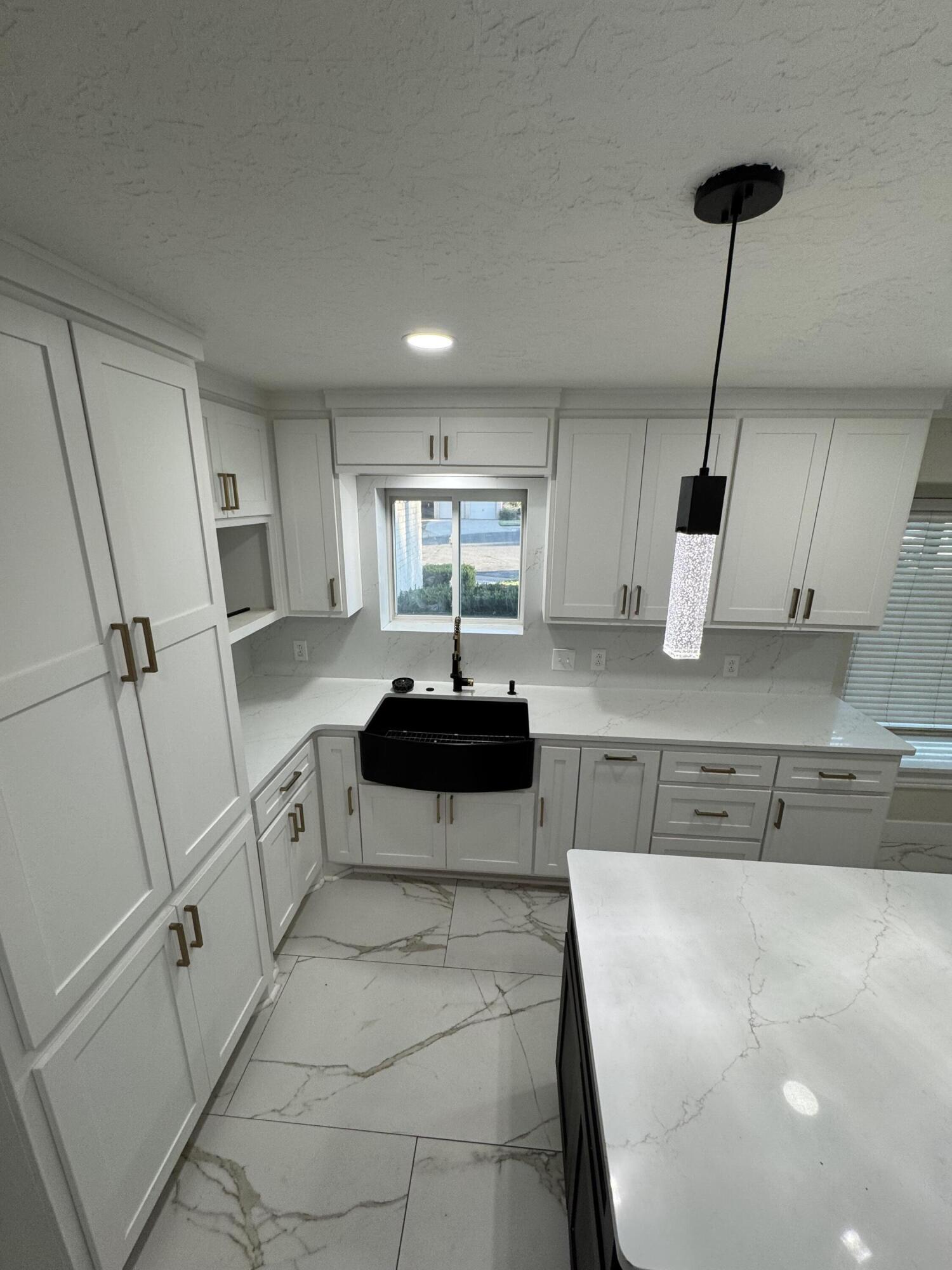 4402 78th Street Lubbock, TX 79424 - Photo 12 of 43 a kitchen with stainless steel appliances a sink a stove a refrigerator and cabinets