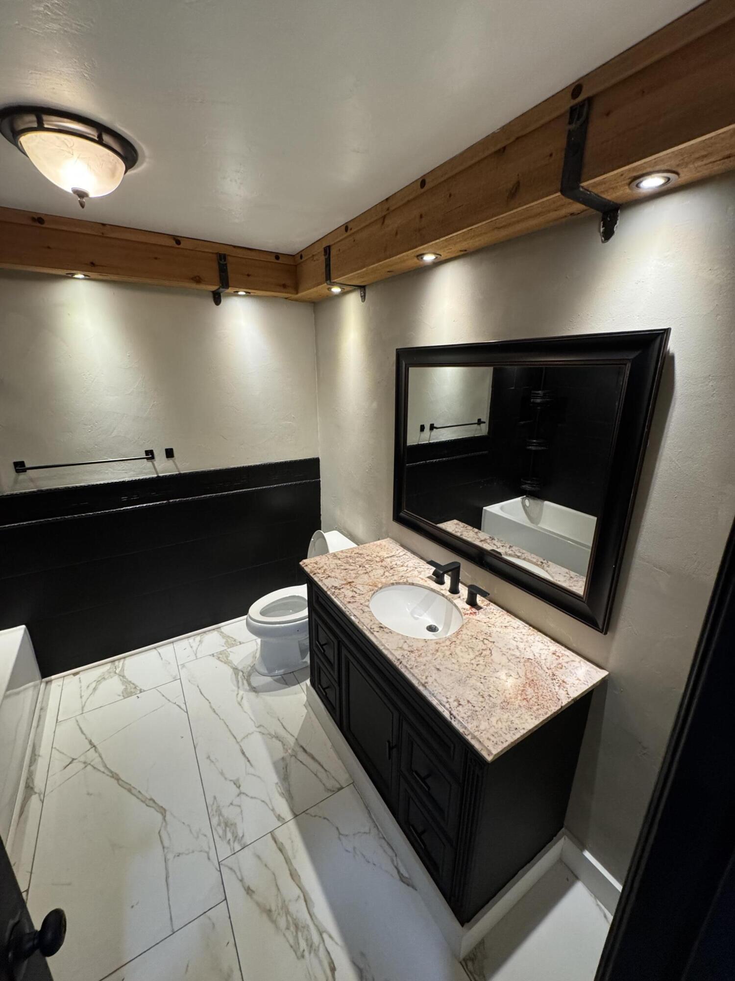 4402 78th Street Lubbock, TX 79424 - Photo 31 of 43 a living room with a flat screen tv and a ceiling fan