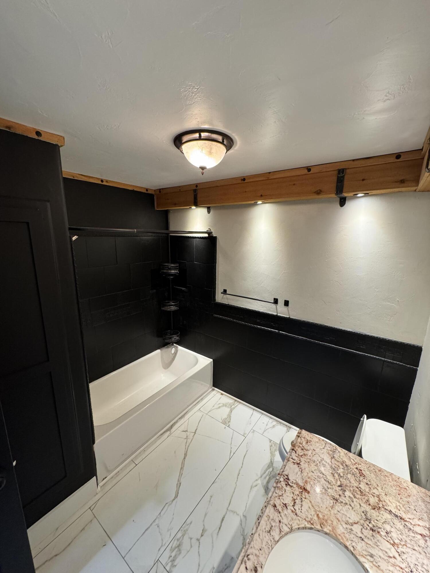 4402 78th Street Lubbock, TX 79424 - Photo 32 of 43 a bathroom with a sink and a mirror