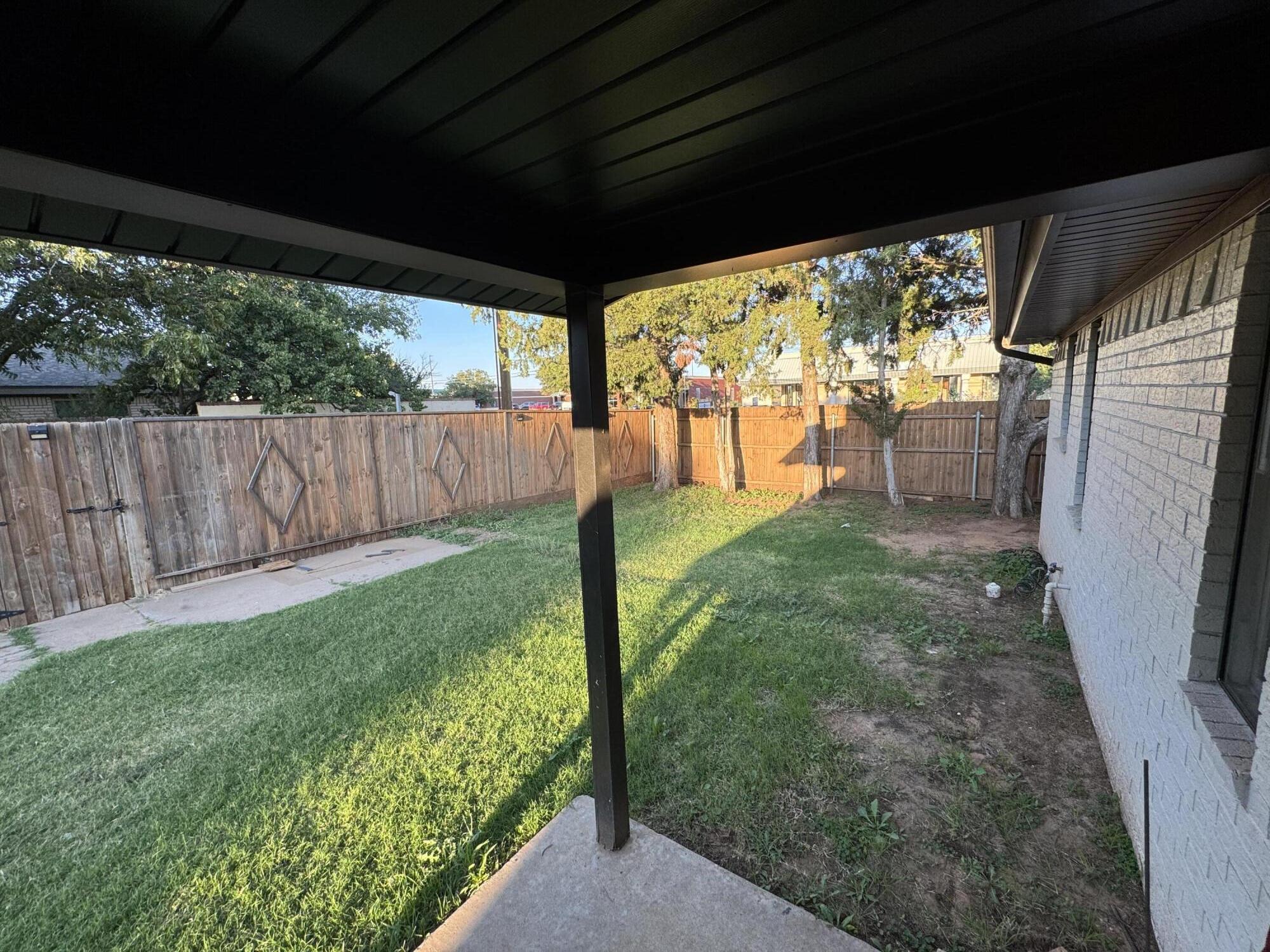 4402 78th Street Lubbock, TX 79424 - Photo 35 of 43 a backyard of a house with a garden and outdoor seating