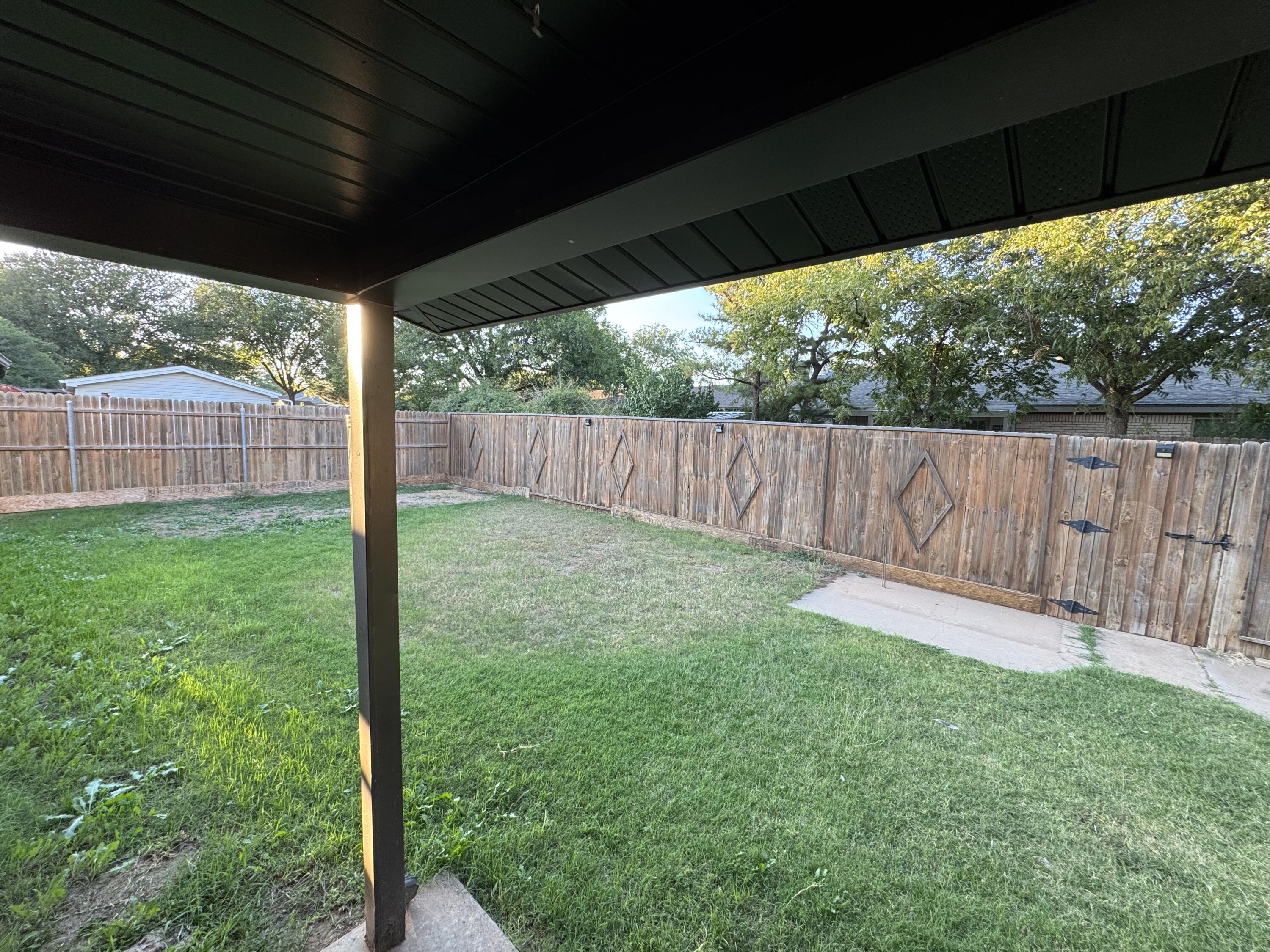 4402 78th Street Lubbock, TX 79424 - Photo 36 of 43 a view of a backyard with a swing