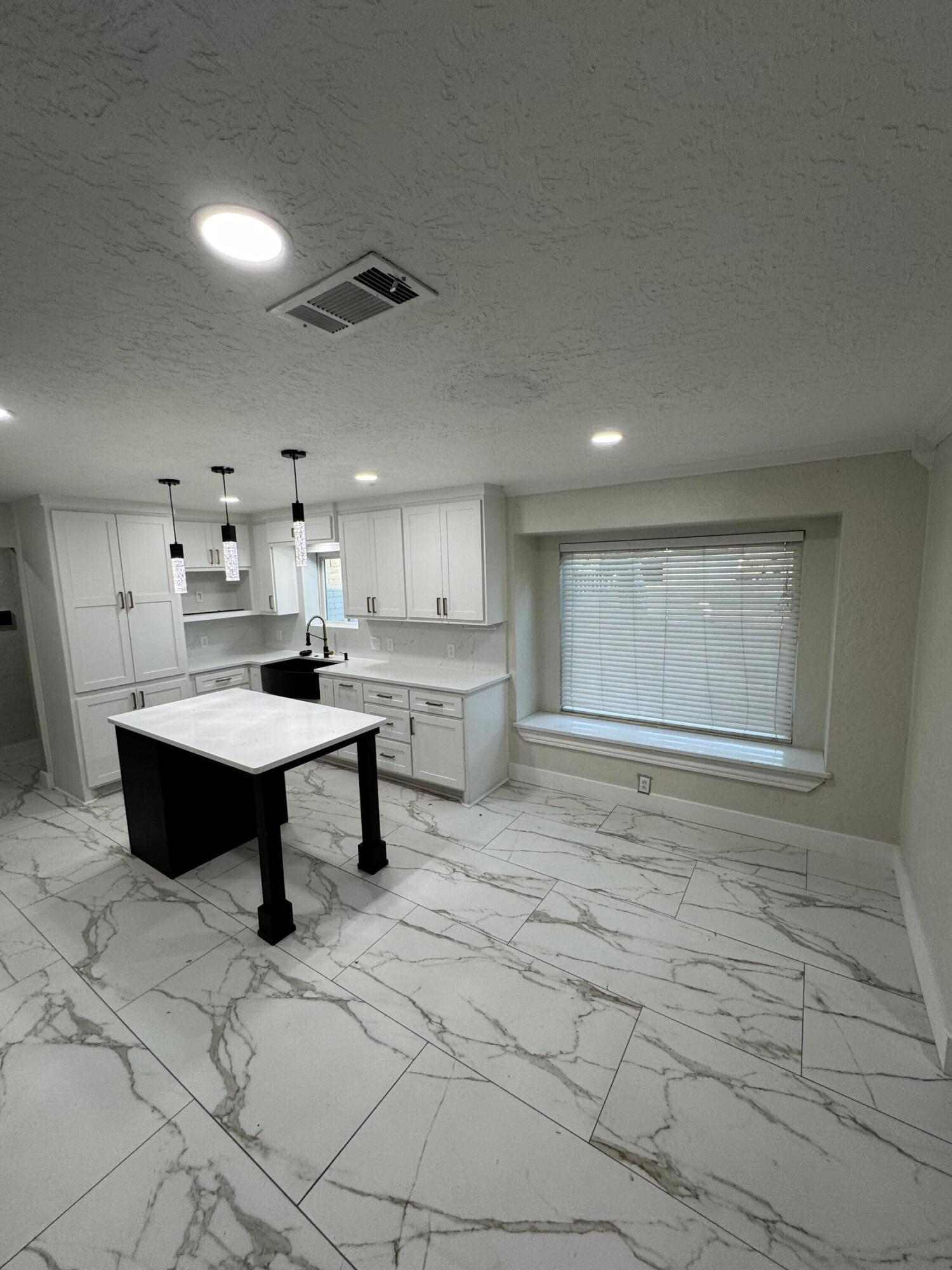 4402 78th Street Lubbock, TX 79424 - Photo 10 of 43 a living room with kitchen furniture and a table