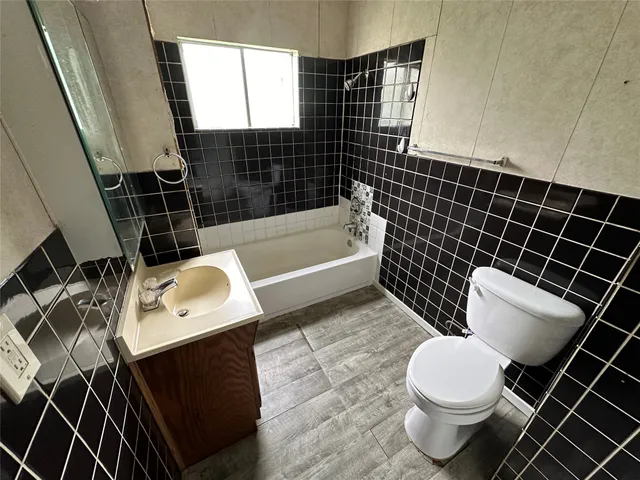 a bathroom with a toilet a sink and bathtub
