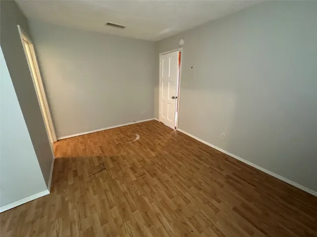an empty room with wooden floor