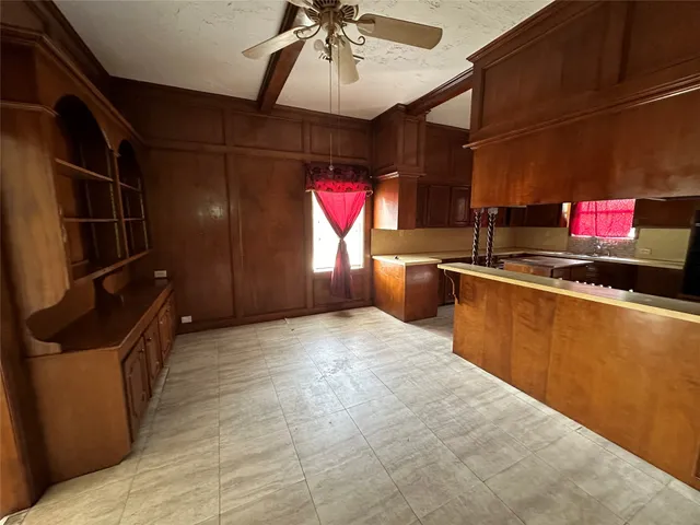 a kitchen with stainless steel appliances granite countertop a sink window and cabinets