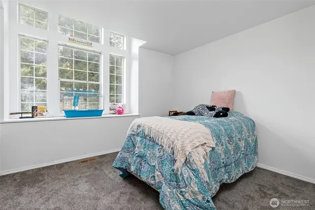a bedroom with a bed and window