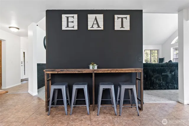 a kitchen with a table and chairs