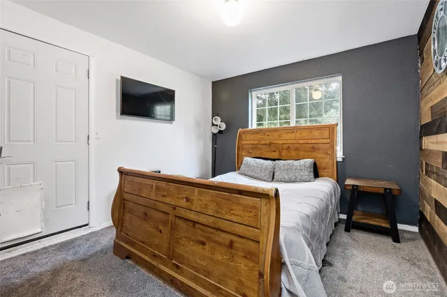 a bedroom with a bed and a television