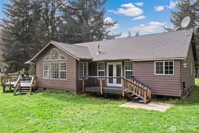 a front view of a house with a garden and deck