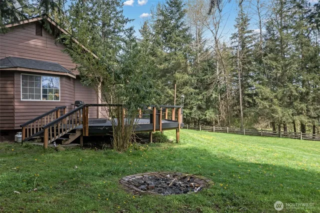 a view of a house with backyard and sitting area