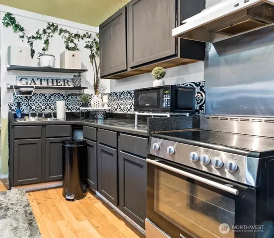 a kitchen with stainless steel appliances granite countertop a stove and a refrigerator
