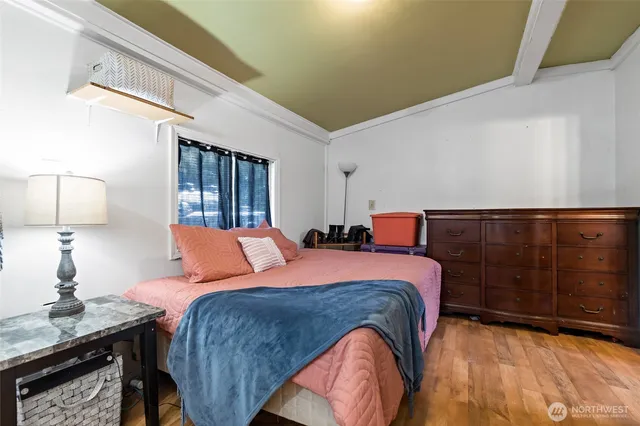 a bedroom with a bed a lamp and window