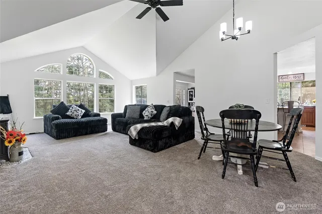a living room with furniture a chandelier and a large window