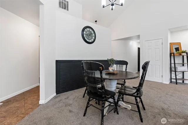 a view of a dining room with furniture and a table & chairs