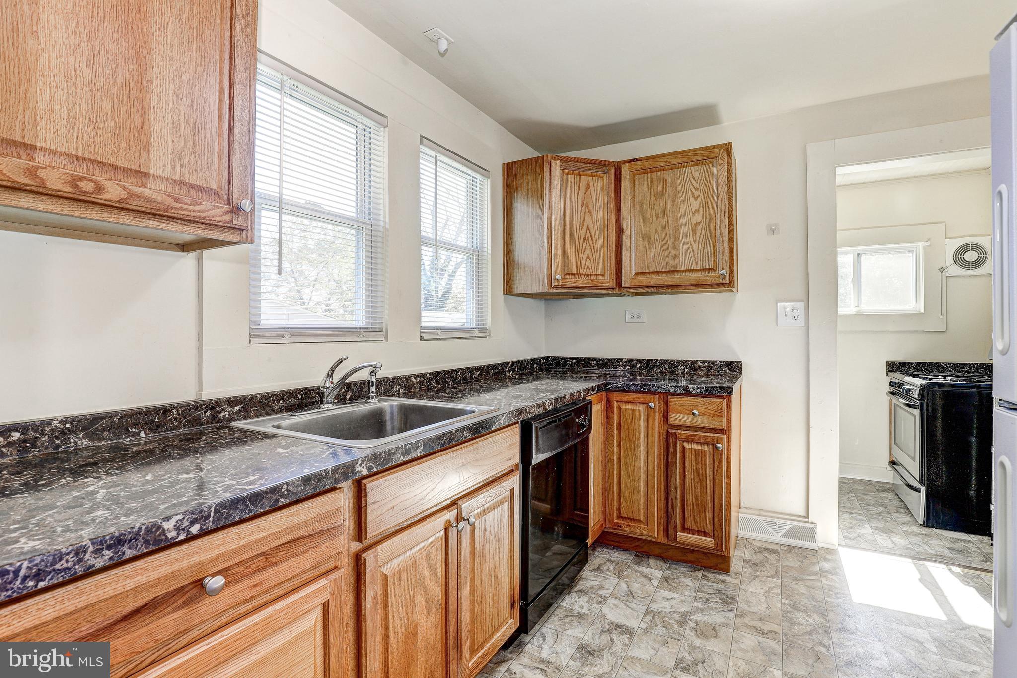 15 Ritters Lane Owings Mills, MD 21117 - Photo 11 of 30 a kitchen with granite countertop a sink stove and cabinets