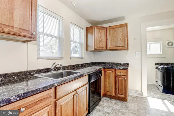 a kitchen that has a sink and a stove