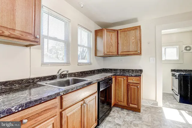 a kitchen that has a sink and a stove