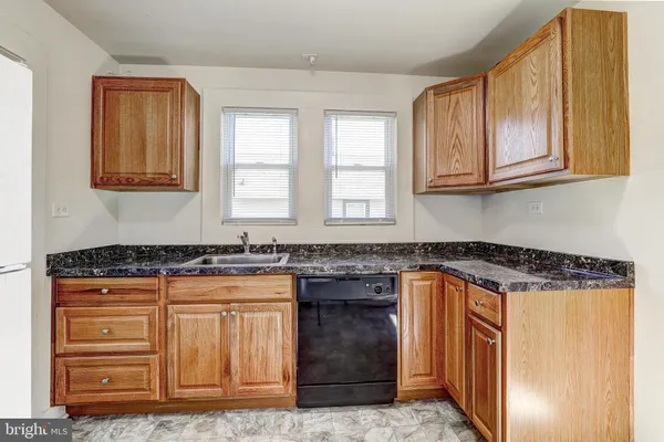 a kitchen with granite countertop a stove and a sink