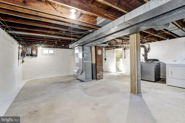 a view of water heater room with refrigerator