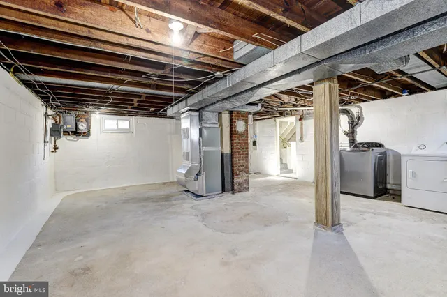 a view of water heater room with refrigerator