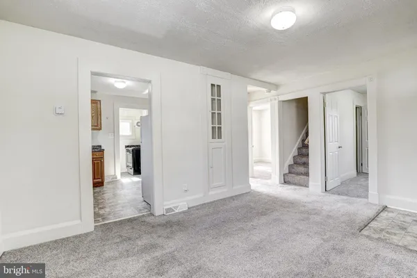 an empty room with windows and bathroom view
